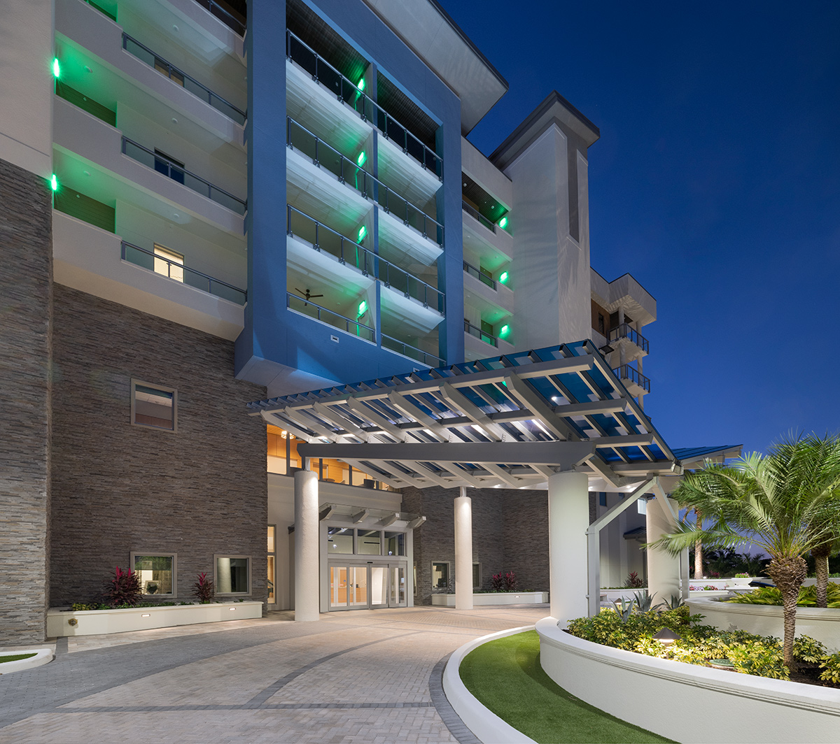 Architectural dusk entrance view of Moorings Grand Lake Clubhouse - Naples, FL.