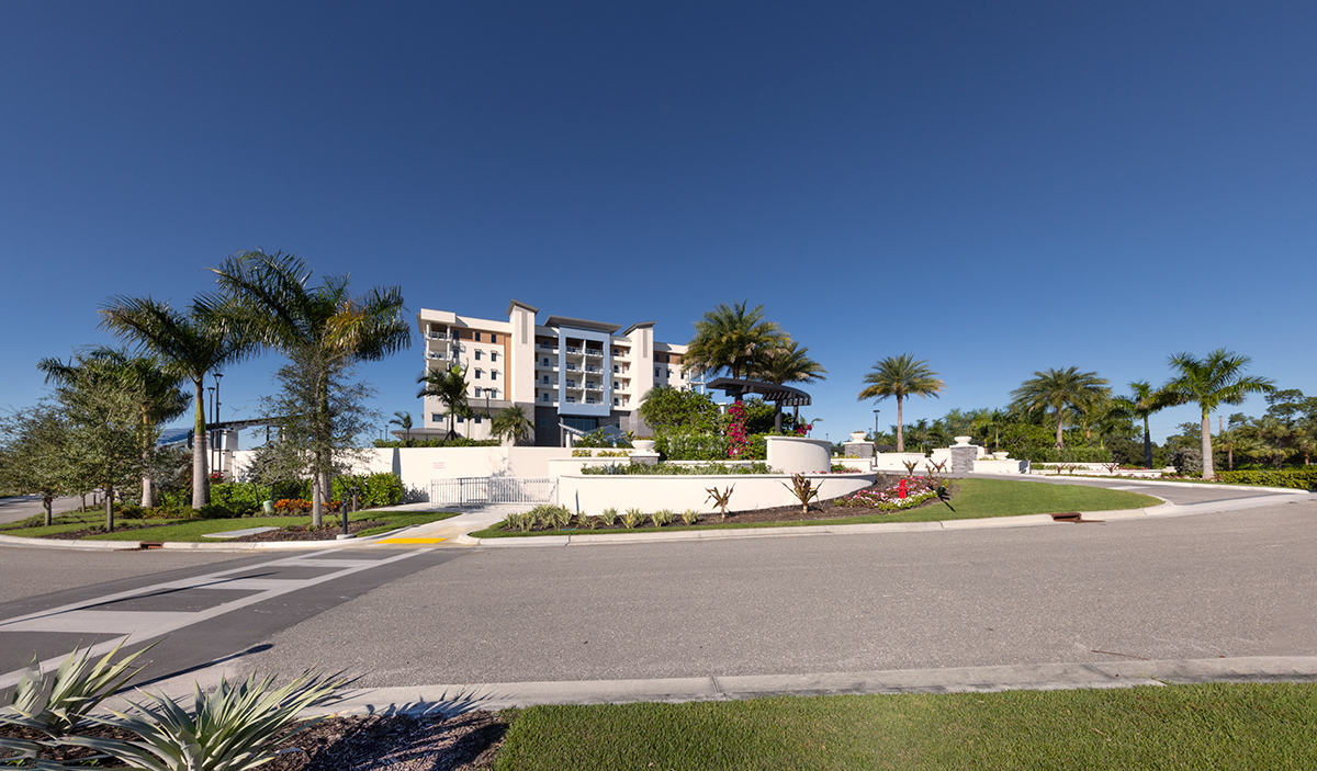 Architectural landscape view of Moorings Grand Lake Clubhouse - Naples, FL.