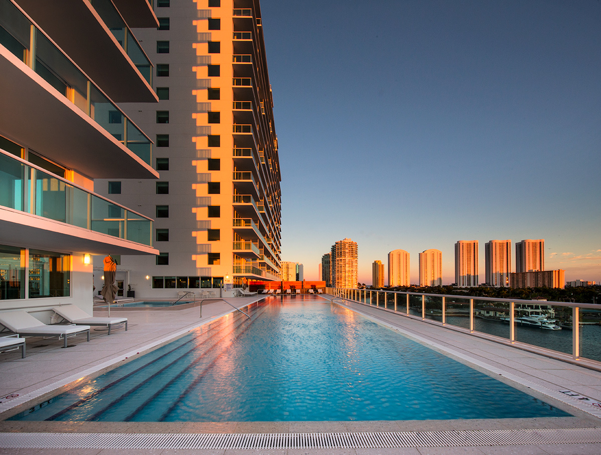 Architectiural dusk view of the pool deck at the 400 Sunny Isles condo.