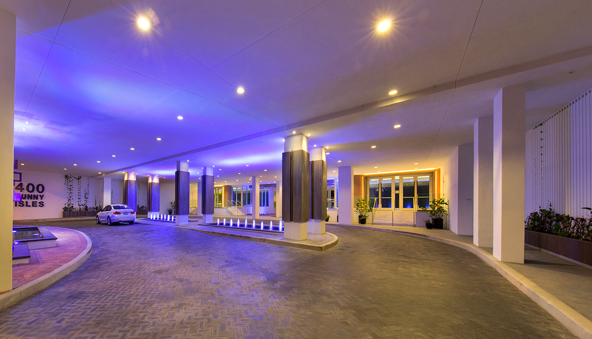 Architectiural dusk view of the entrance at the 400 Sunny Isles condo.