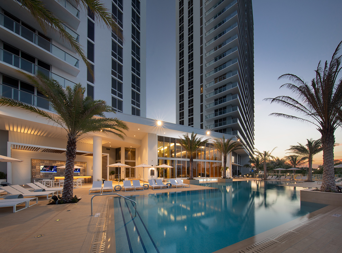 Architectural dusk pool view of the Harbour Condo Tower N Miami Beach, FL