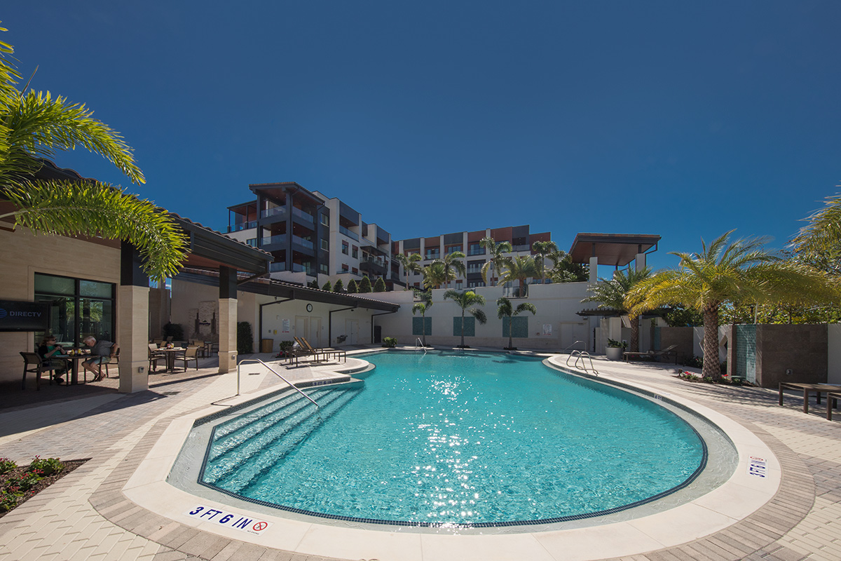 Architectural pool view of Moorings Park at Grey Oaks senior living in Naples, FL.